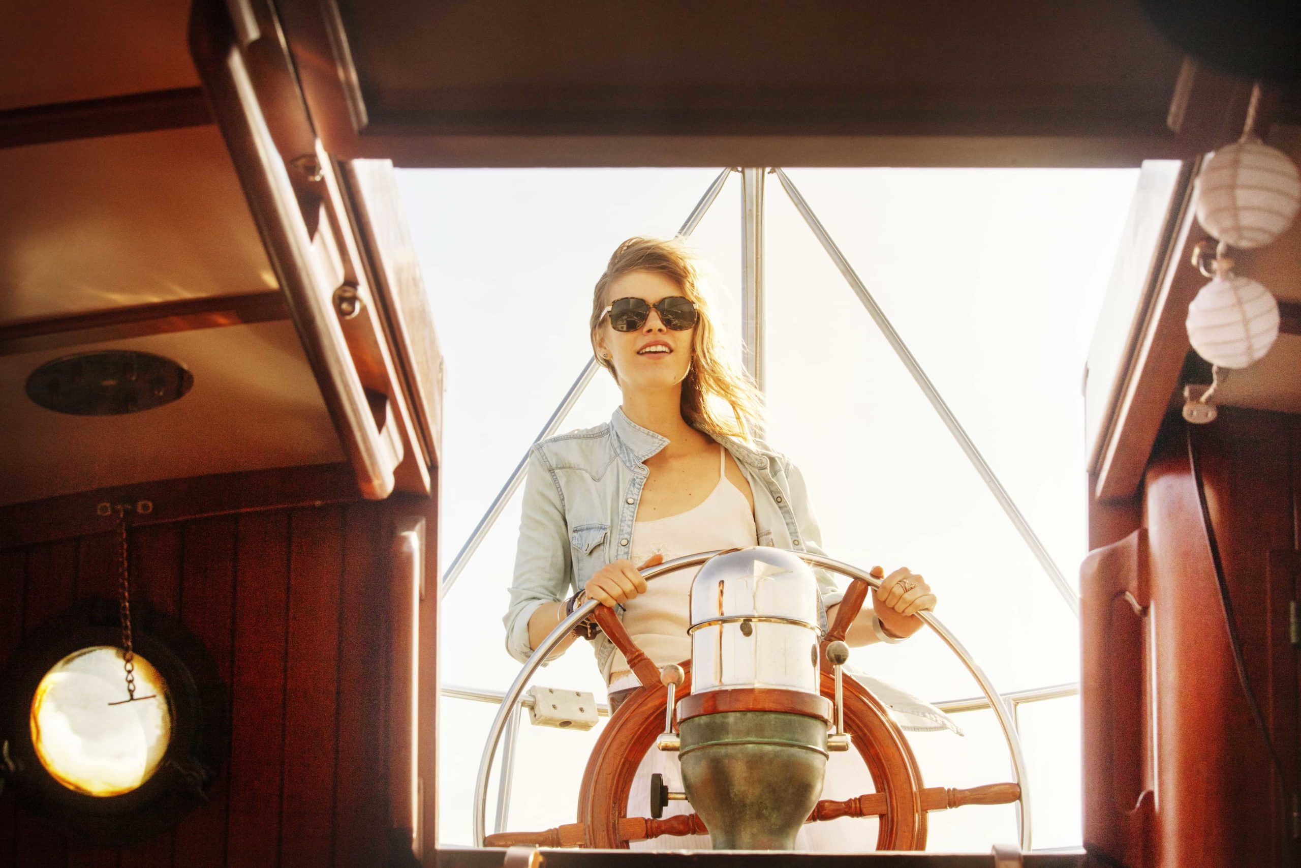 woman-with-sunglasses-sailing-yacht-2022-05-26-00-35-35-utc-min