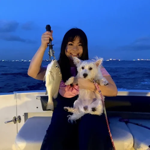 Customer14 with west highland white terrier. Dog friendly packages for dog cruise provided by Wanderlust Adventure best Singapore yacht rental.