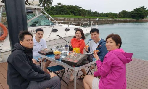 Family Enjoying Pizza On Docks